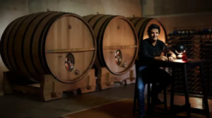 larry cherubino sitting in front of wine barrels