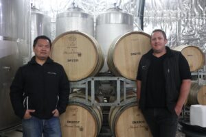 silkwood winery, pemberton,wine barrels in the background with the winemakers.
