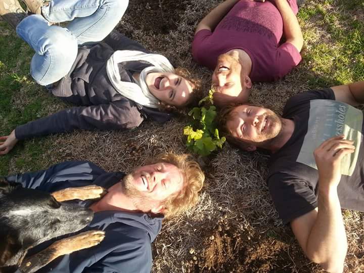 out on a limb winery, family sitting on the ground.